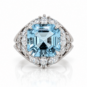 18ct White gold ring featuring a centre square emerald cut aquamarine with a bouquet of diamonds