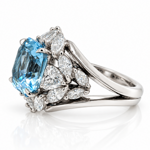 18ct White gold ring featuring a centre square emerald cut aquamarine with a bouquet of diamonds