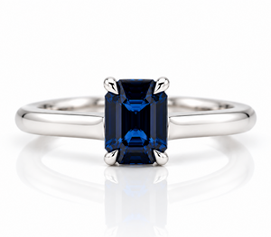 Emerald cut sapphire claw set in a platinum ring