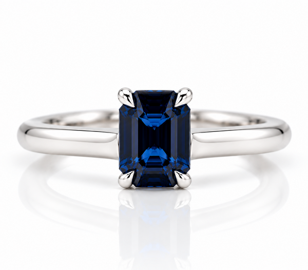 Emerald cut sapphire claw set in a platinum ring