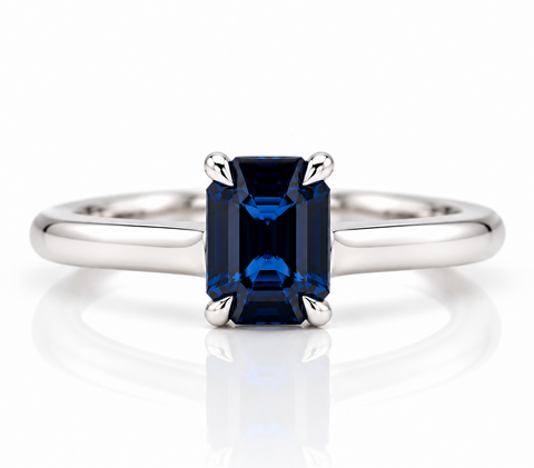 Emerald cut sapphire claw set in a platinum ring