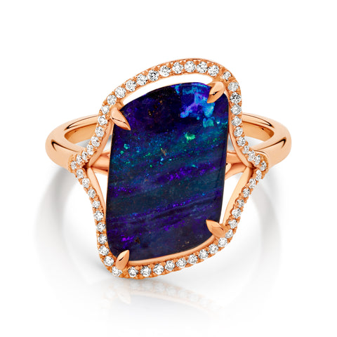 Rose gold ring with an australian opal and diamond accents on a white background