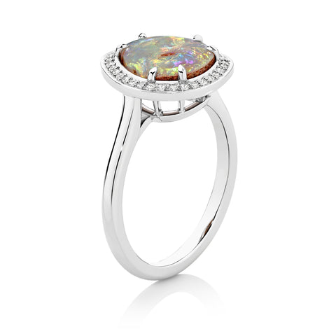 Platinum ring with a colorful opal stone on a white background