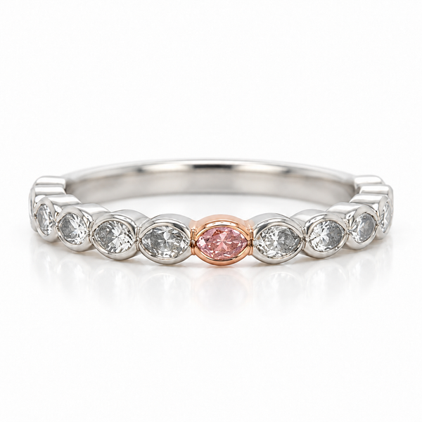 A silver-toned eternity ring featuring a row of clear oval diamond with a single rose gold oval center stone, shown on a white background with a soft reflection.