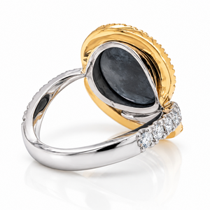 A two-tone ring featuring a polished yellow gold bezel-set oval stone and a silver-toned band accented with small clear stones, shown on a clean white background.